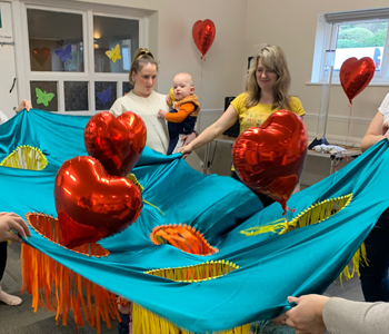 Teacher entertaining with heart ballons