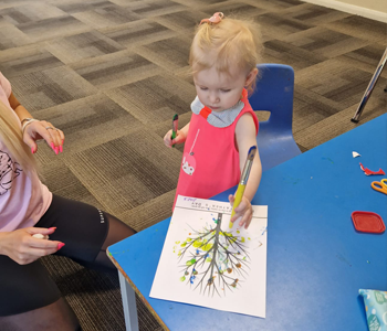 Child drawing at a craft table