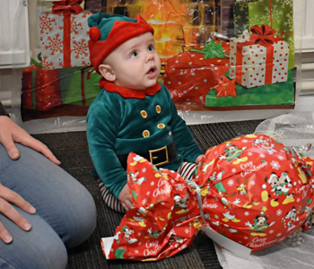 Children decorating a paper christmas tree