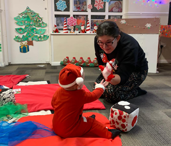 Parents and teacher entertaining children